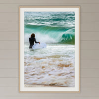 Short Point Surfer framed print in oak with a white mat, on a coastal lounge room wall