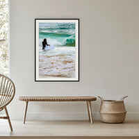 Short Point Surfer framed print in black with a white mat, in a cane-panelled hallway
