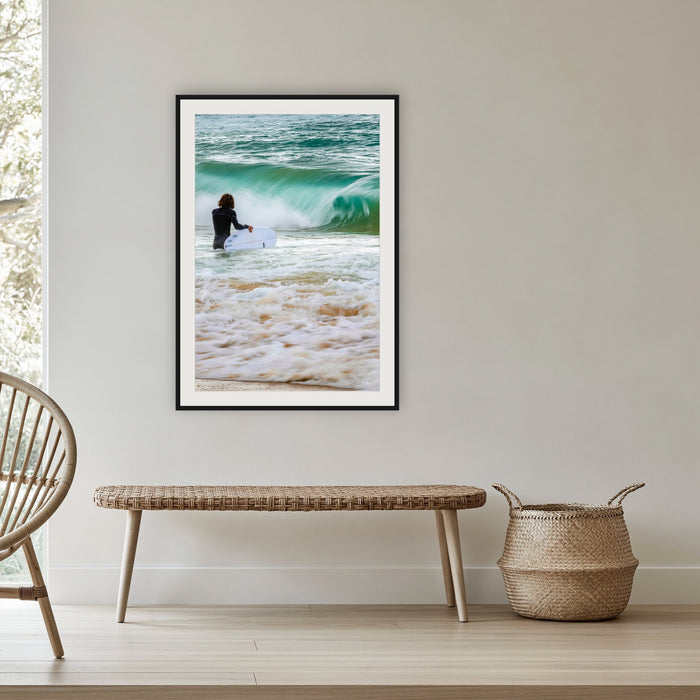 Short Point Surfer framed print in black with a white mat, in a cane-panelled hallway