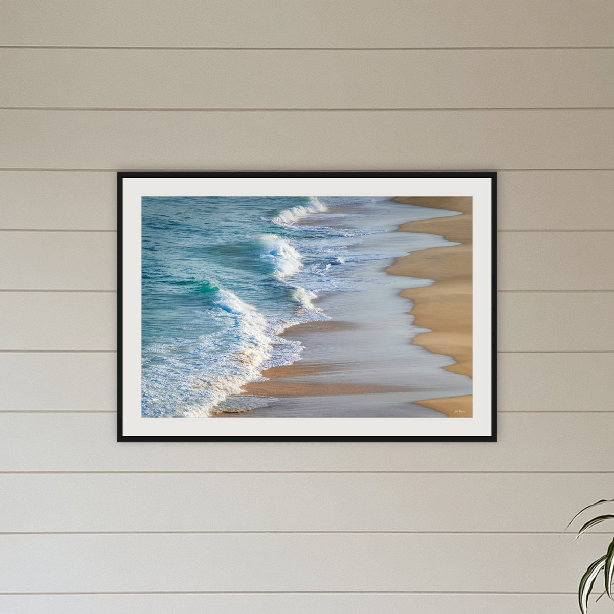 Tura Beach Waves framed print in black with a white mat, on a coastal lounge room wall