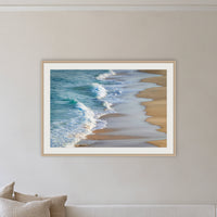 Tura Beach Waves framed print in oak with a white mat, above a sofa