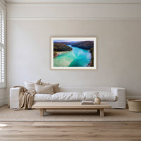 Pambula River to the Mountains framed print in oak with a white mat, on a coastal lounge room wall