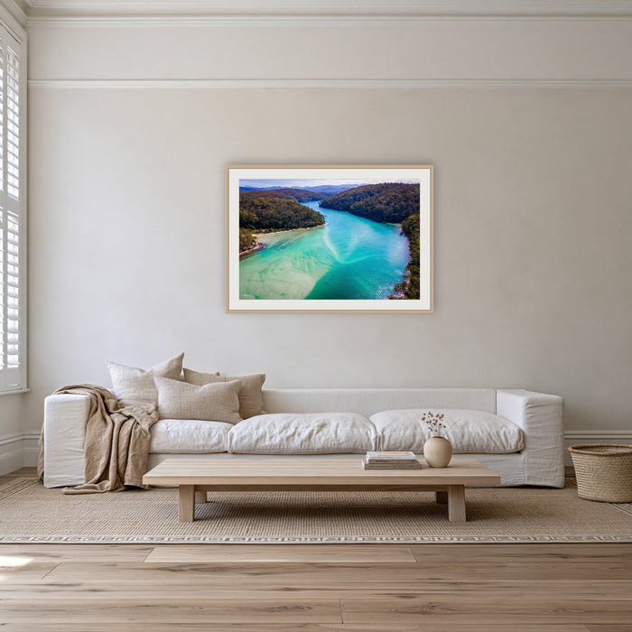 Pambula River to the Mountains framed print in oak with a white mat, on a coastal lounge room wall