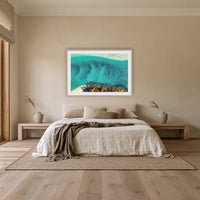 Pambula River Bird's Eye View framed print in oak with a white mat, above an oatmeal linen bed in a bedroom