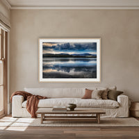 Storm Clouds over Top Lake framed print in oak with a white mat, above an oatmeal linen sofa in a lounge room