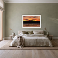 Top Lake Oyster Leases at Sunset framed print in oak with a white mat, above a linen bed against a sage wall in a bedroom
