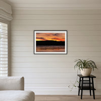 Top Lake Oyster Leases at Sunset framed print in black with a white mat, above a sofa