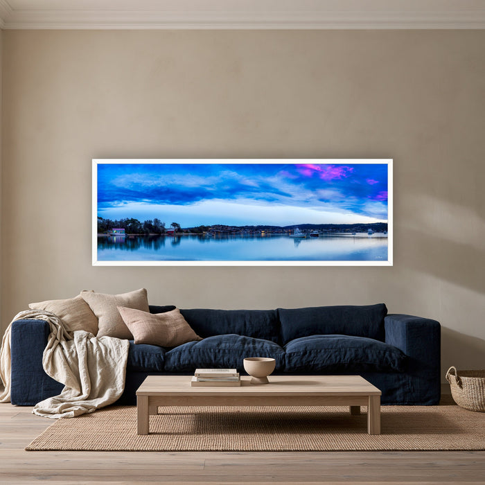 Dawn Delight super wide panorama in a white frame above a navy linen sofa — wall art, Merimbula NSW