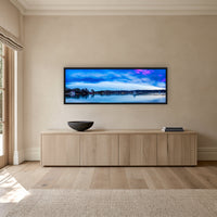 Dawn Delight super wide panorama in a black frame above a long oak sideboard — wall art, Merimbula NSW