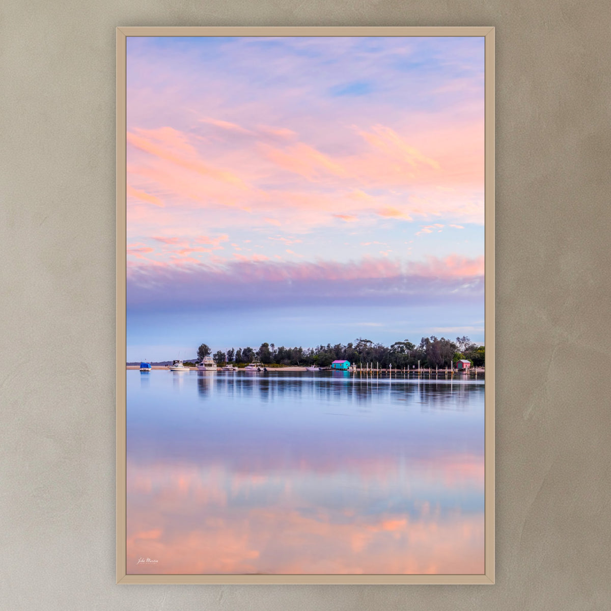 Pastel Pink Paradise in an oak frame without a mat, in a plaster-walled hallway