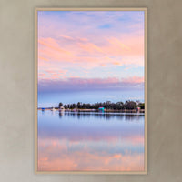 Pastel Pink Paradise in an oak frame without a mat, in a plaster-walled hallway