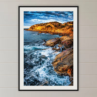 Tathra Rocks framed print in black with a white mat, in a shiplap hallway