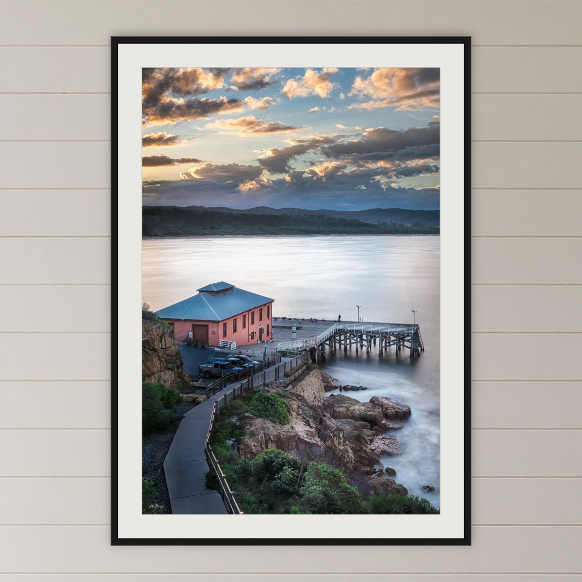 Tathra Wharf Smooth Seas framed print in black with a white mat, in a coastal bedroom
