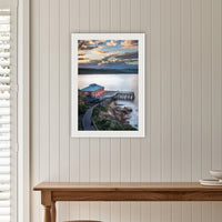 Tathra Wharf Smooth Seas framed print in white with a mat, on a panelled hallway wall