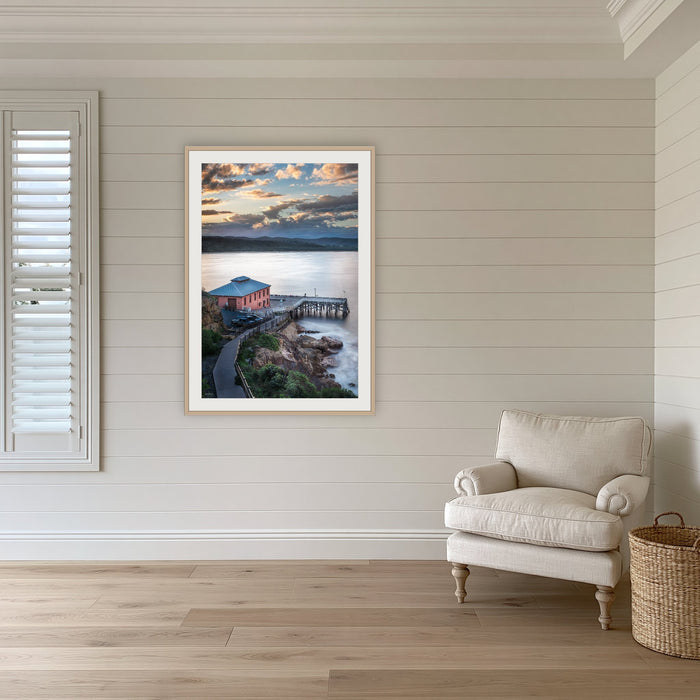 Tathra Wharf Smooth Seas framed print in oak with a white mat, in a coastal lounge room