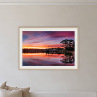 Spencer Park framed print in oak with a white mat, on a coastal lounge room wall