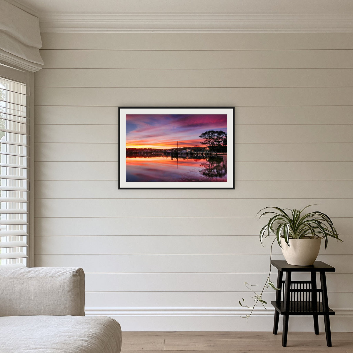 Spencer Park framed print in black with a white mat, above a sofa