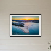Fishpen Aerial View framed print in black with a white mat, above a sofa