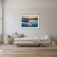 Fishpen Aerial View framed print in oak with a white mat, on a coastal lounge room wall