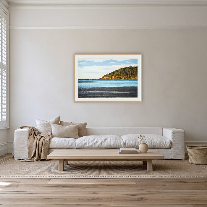 Pambula River Sea Entrance framed print in oak with a white mat, on a coastal lounge room wall