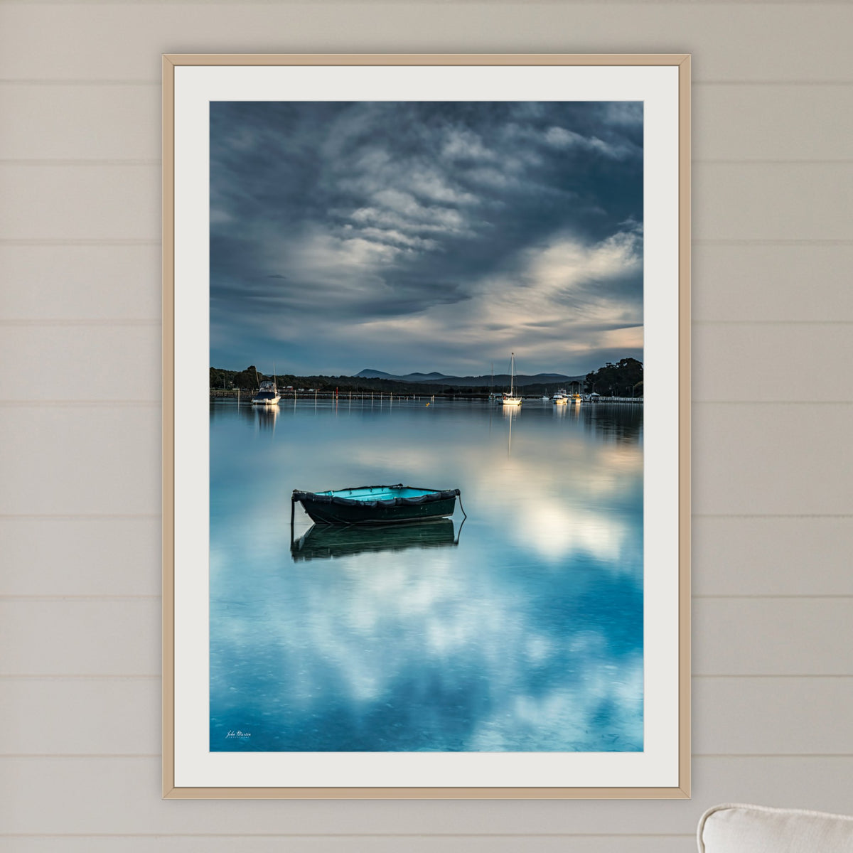 Little Boat framed print in oak with a white mat, in a coastal lounge room