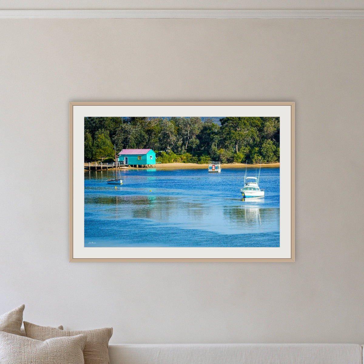 Mitchies Jetty framed print in oak with a white mat, on a coastal lounge room wall