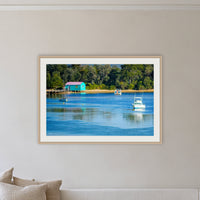 Mitchies Jetty framed print in oak with a white mat, on a coastal lounge room wall
