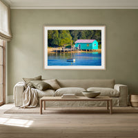 Mitchies Jetty Close Up framed print in oak with a white mat, above a linen sofa against a sage wall in a lounge room