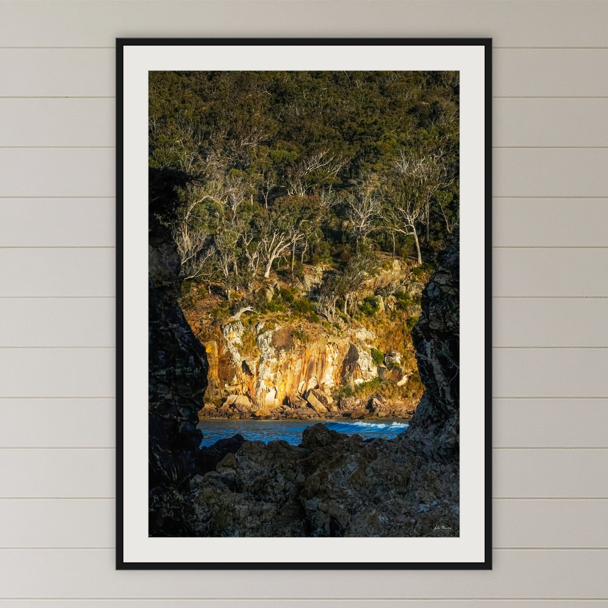 Pambula Beach Rock Frame framed print in black with a white mat, in a coastal bedroom