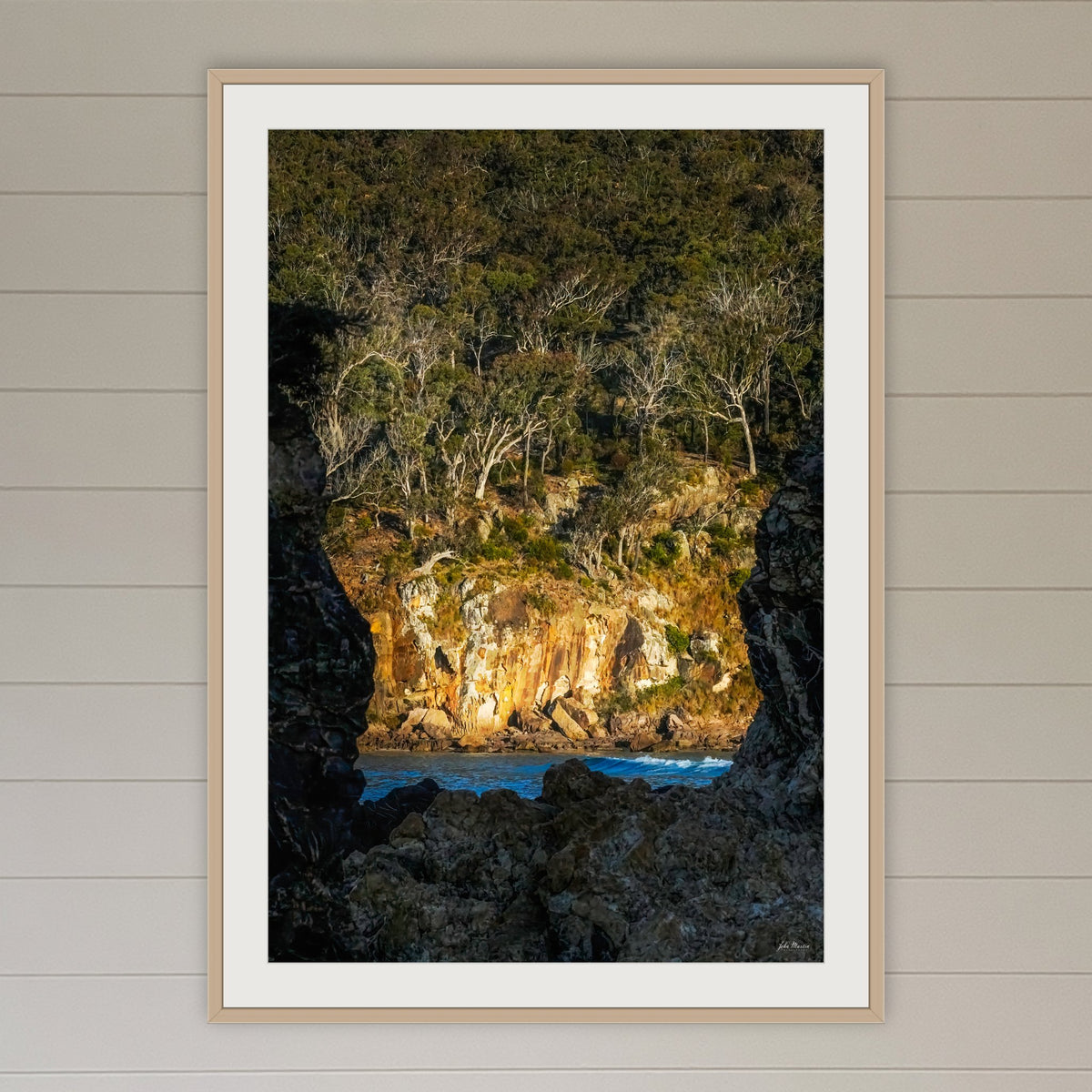 Pambula Beach Rock Frame framed print in oak with a white mat, in a coastal lounge room