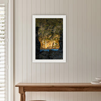 Pambula Beach Rock Frame framed print in white with a mat, on a panelled hallway wall
