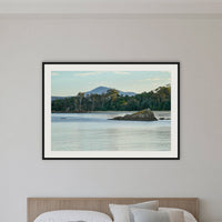 Twofold Bay framed print in black with a white mat, in a bedroom