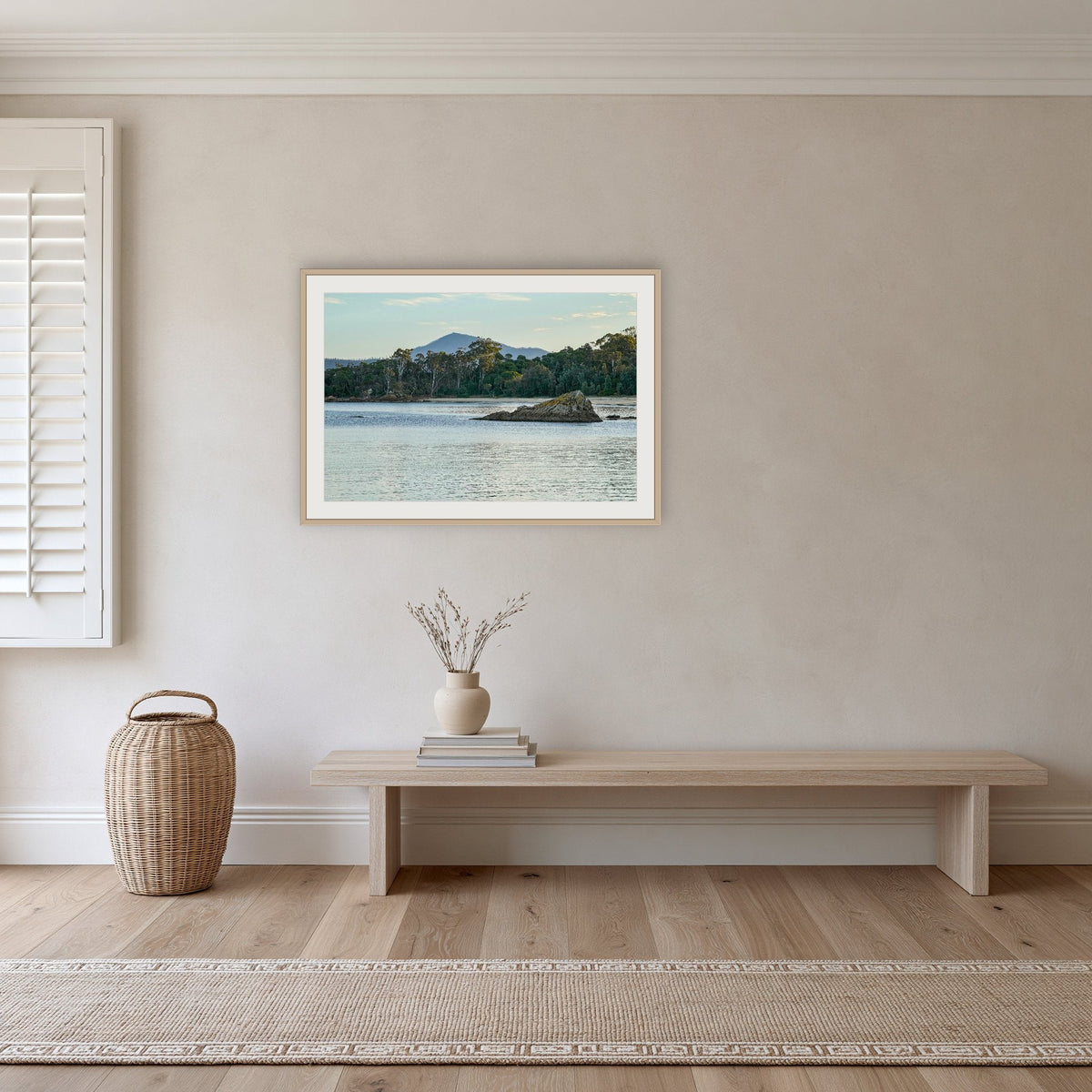 Twofold Bay framed print in oak with a white mat, in a hallway