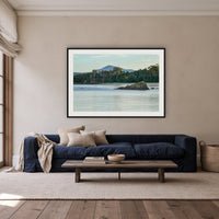 Twofold Bay, Eden framed print in black with a white mat, above a navy linen sofa in a lounge room