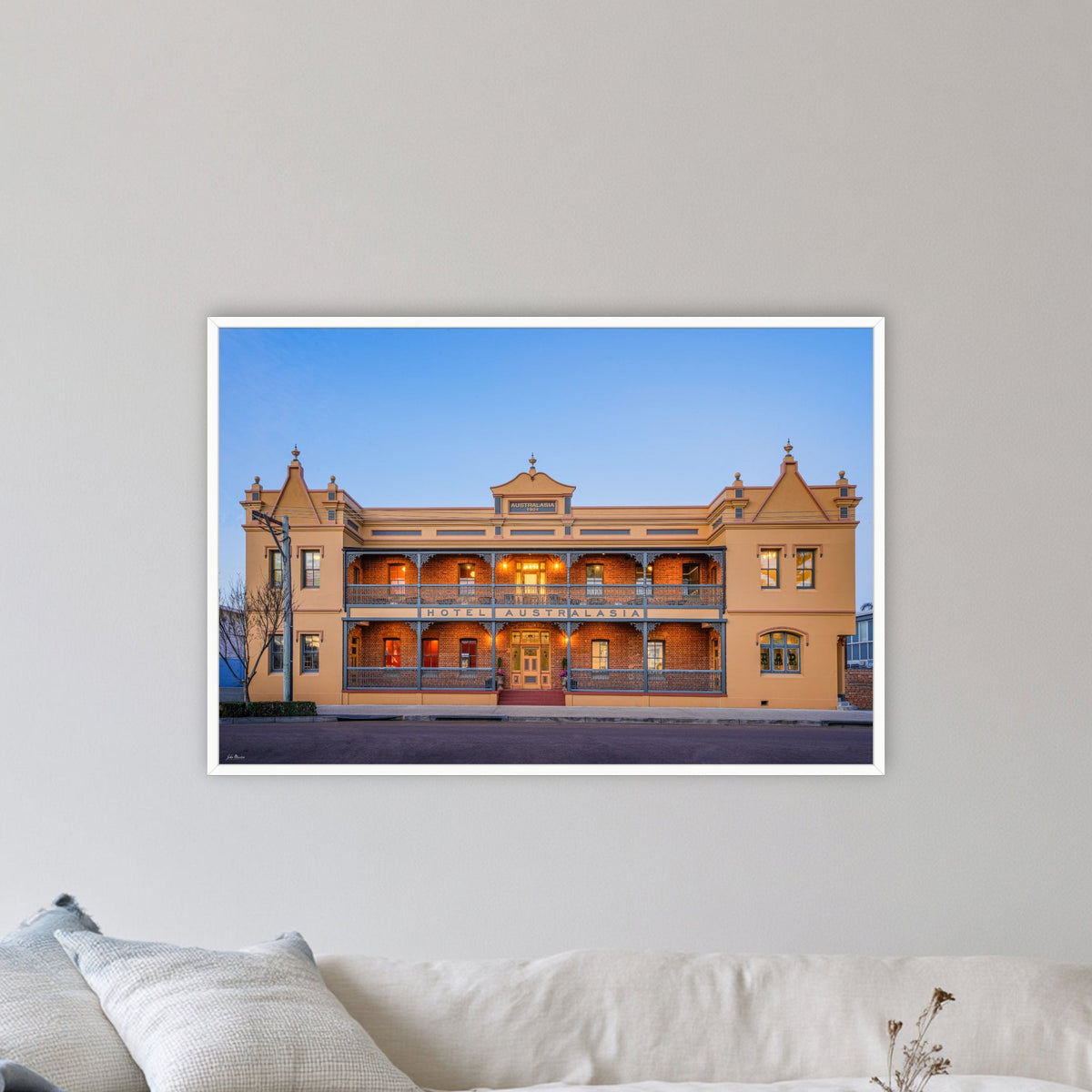 Hotel Australasia in a white frame without a mat, in a coastal lounge room