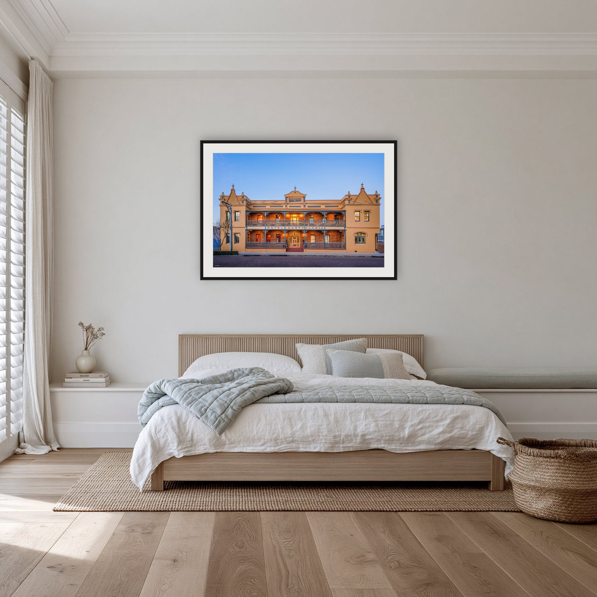 Hotel Australasia framed print in black with a white mat, on a coastal bedroom wall