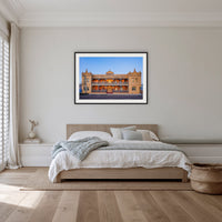Hotel Australasia framed print in black with a white mat, on a coastal bedroom wall