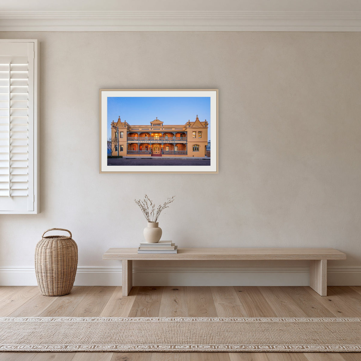 Hotel Australasia framed print in oak with a white mat, in a hallway