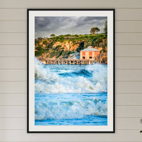 Tathra Wharf and Waves framed print in black with a white mat, in a coastal bedroom