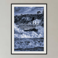 Tathra Wharf and Waves in black and white, framed print in black with a white mat, in a cane-panelled hallway