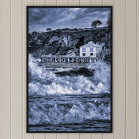 Tathra Wharf and Waves in black and white, in a black frame without a mat, on a panelled hallway wall