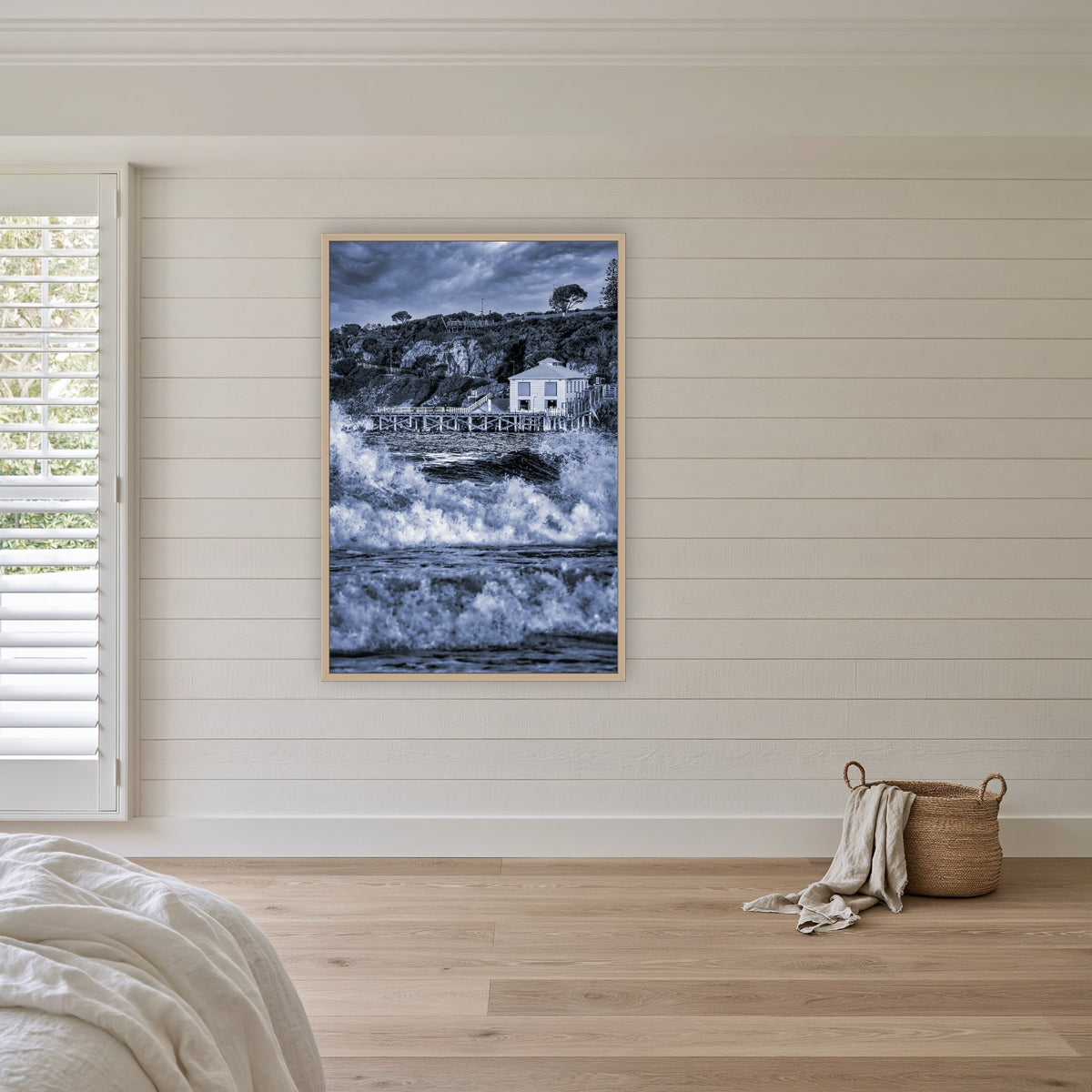 Tathra Wharf and Waves in black and white, in an oak frame without a mat, above the bed in a white coastal bedroom