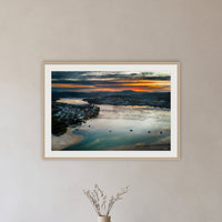 Merimbula Eagle Eye Sunset framed print in oak with a white mat, in a hallway