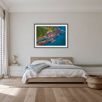 Merimbula Wharf framed print in black with a white mat, in a bedroom
