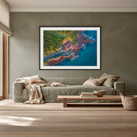 Merimbula Wharf framed print in black with a white mat, above a sage linen sofa in a lounge room