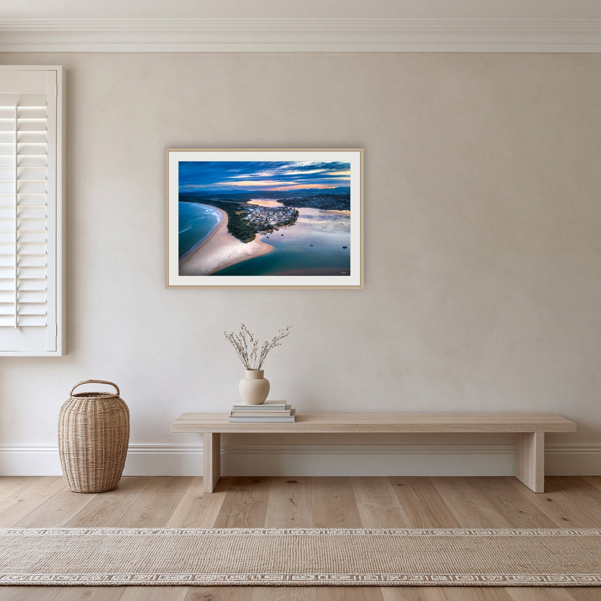 Fishpen on Dusk framed print in oak with a white mat, in a hallway