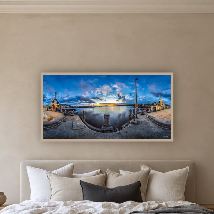 Sunset over Twofold Bay wide panorama in an oak frame above a linen bed — wall art, Eden NSW