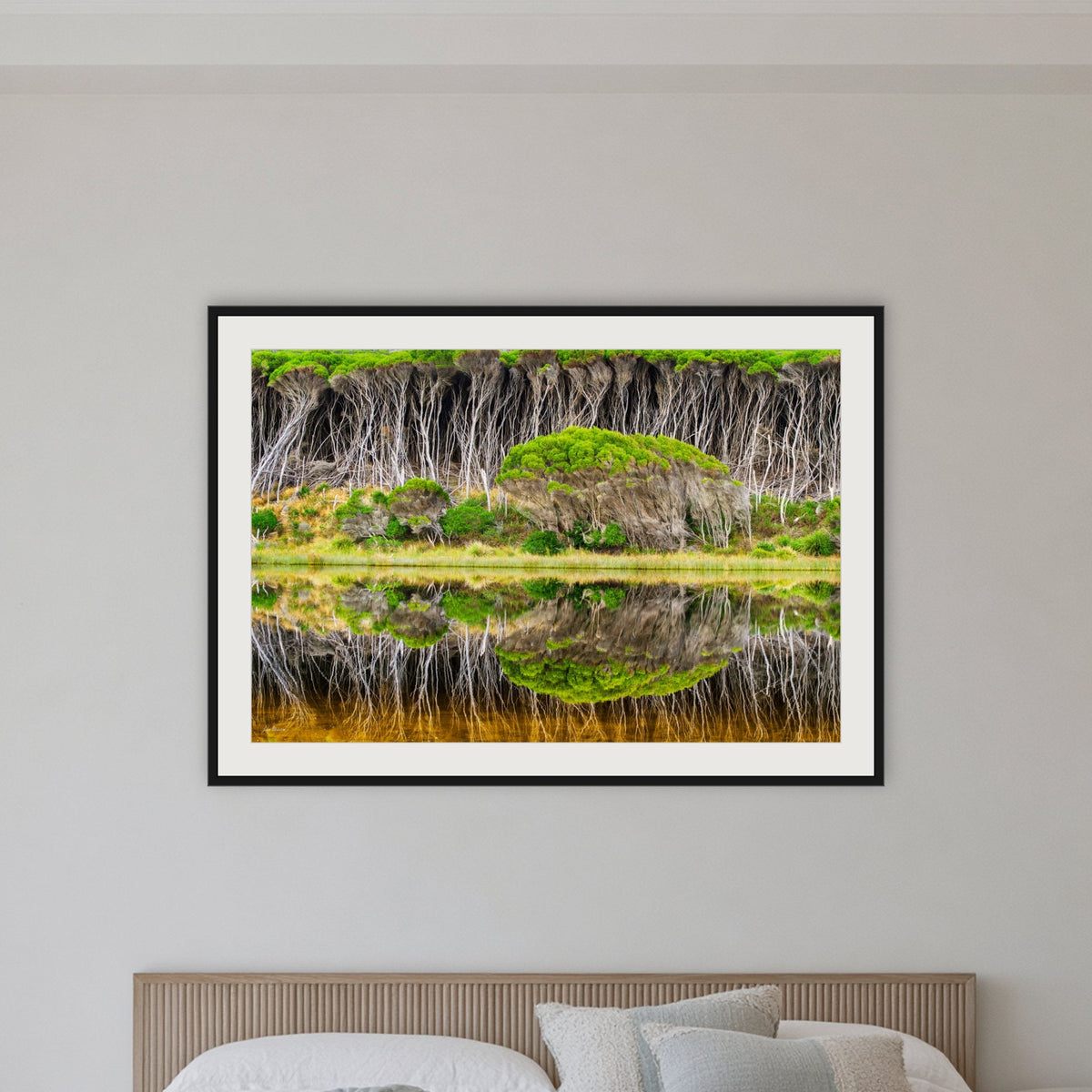 Bournda Lagoon Reflections framed print in black with a white mat, in a bedroom