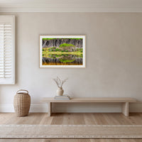 Bournda Lagoon Reflections framed print in oak with a white mat, in a hallway