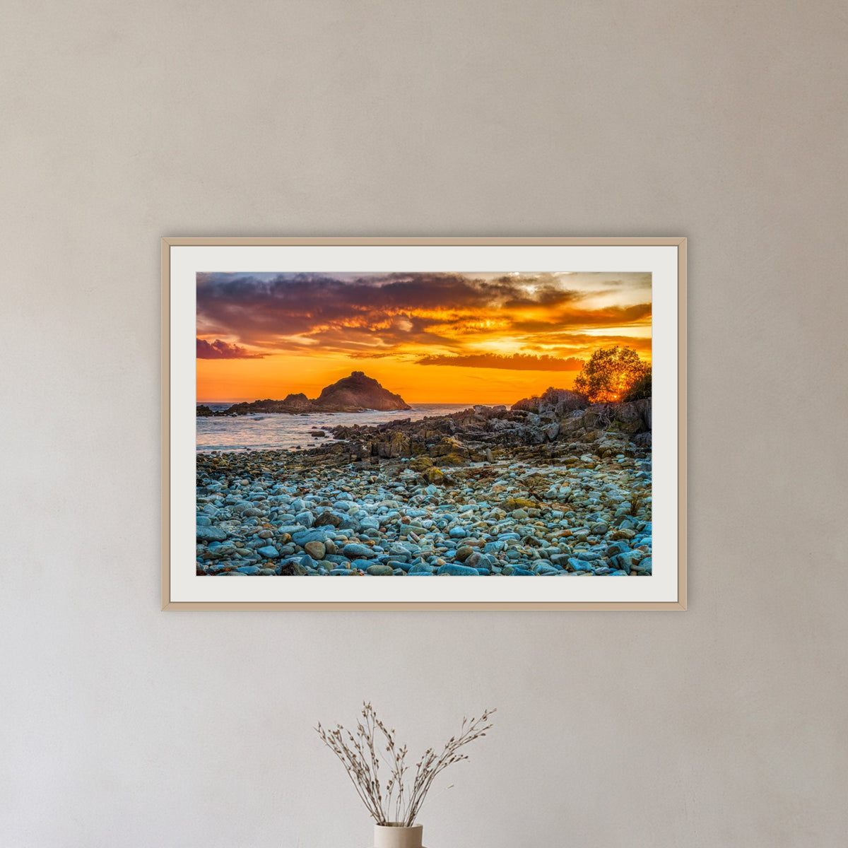 Mimosa Rocks Sunrise framed print in oak with a white mat, in a hallway